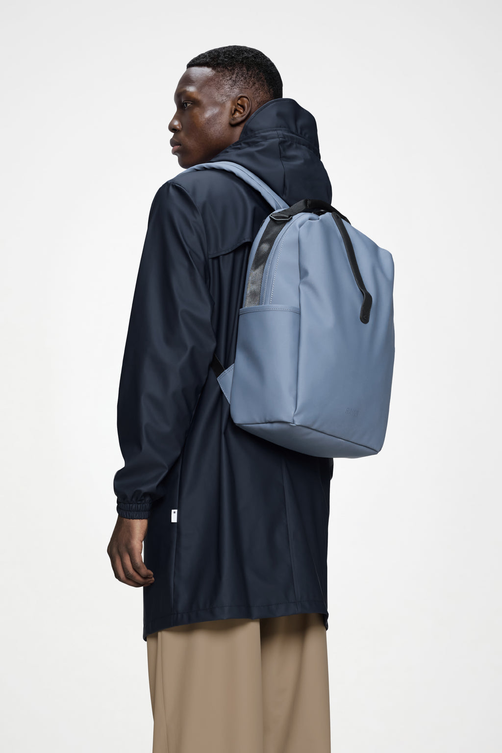 Rains® Clip Front Backpack in Glow for $160